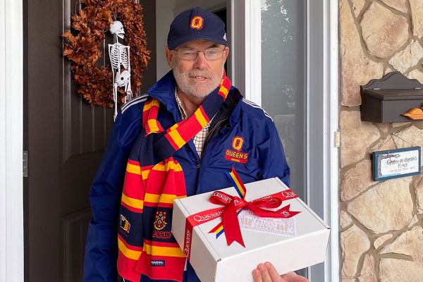 John Armitage receiving a Queen's Day package at his front door.