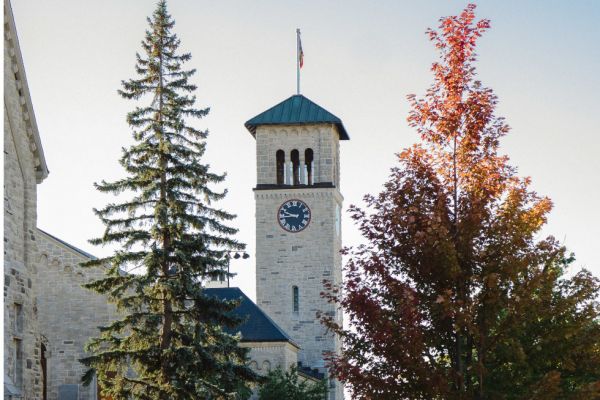 Grant Hall clock tower among autumn trees