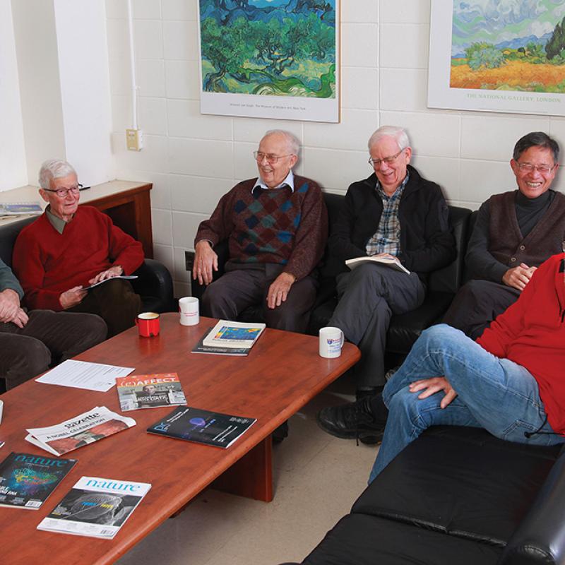 Group of 6 physics colleagues sitting down