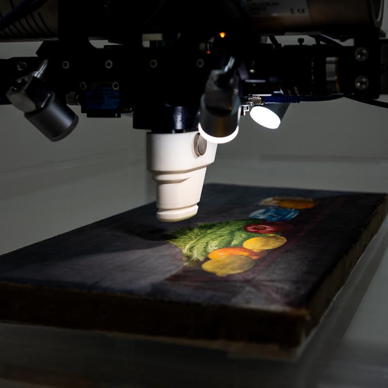 Close-up of a painting being scanned