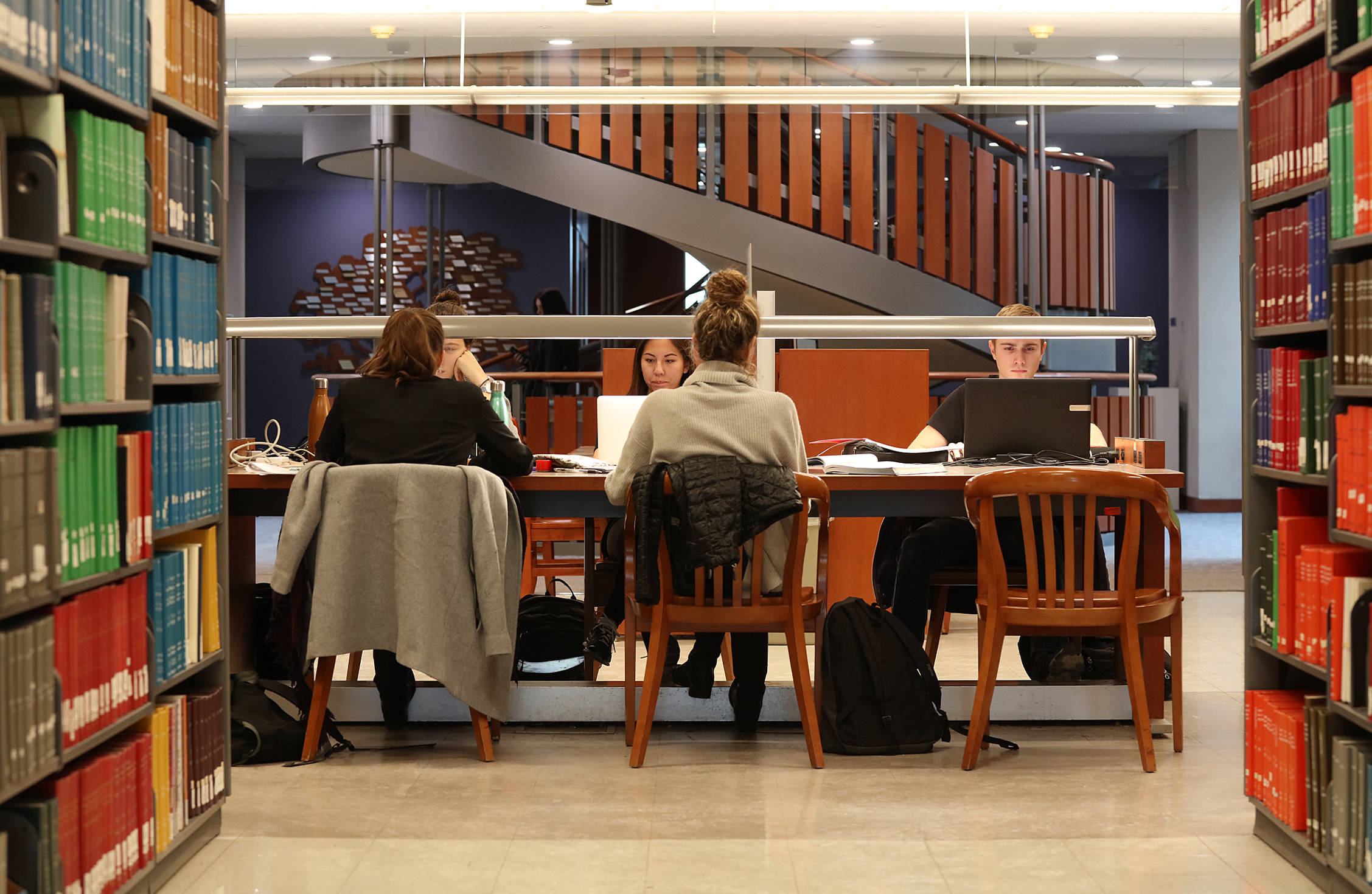 Students working at a table in Stauffer Library.