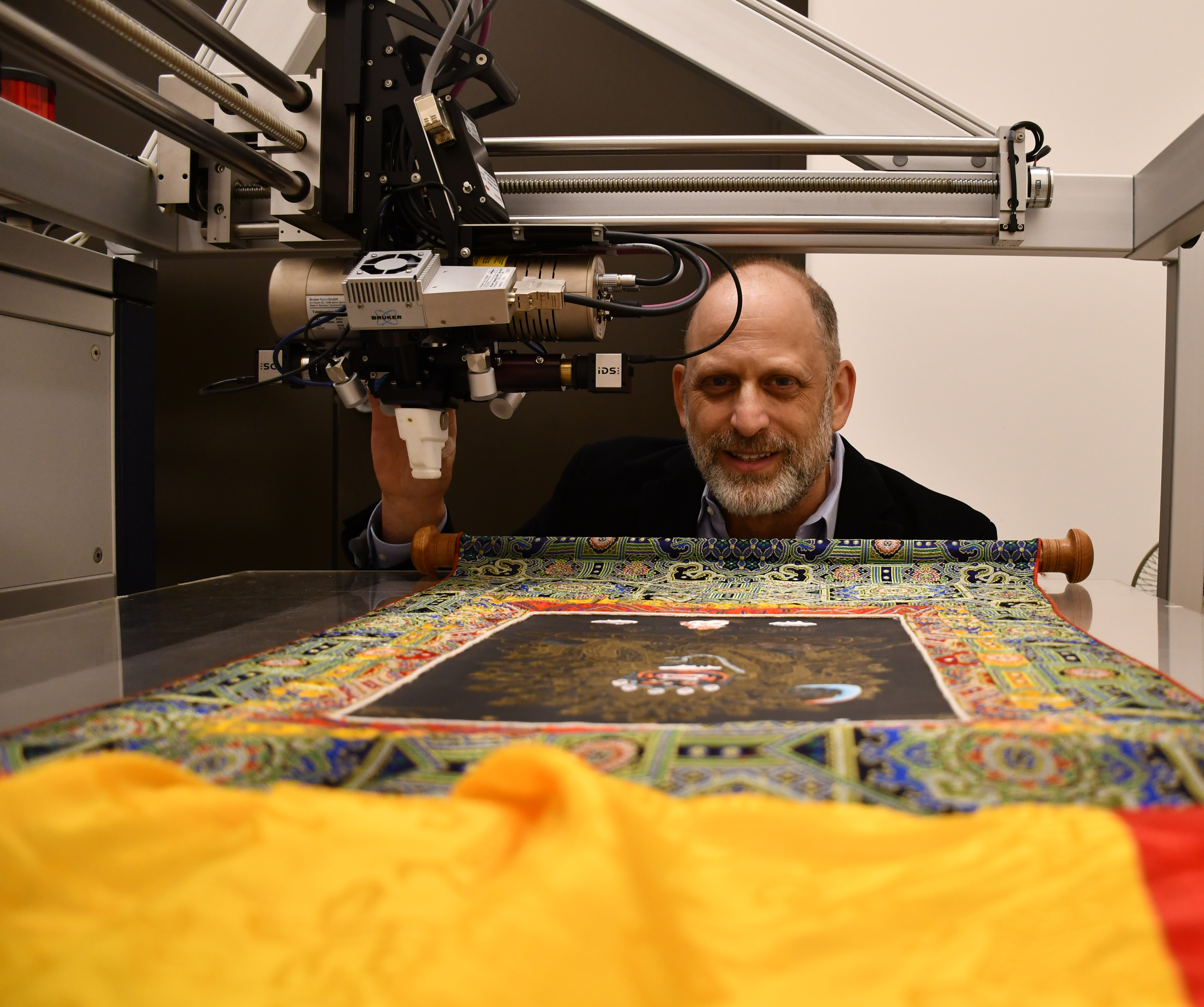 Aaaron Shugar working with a tapestry