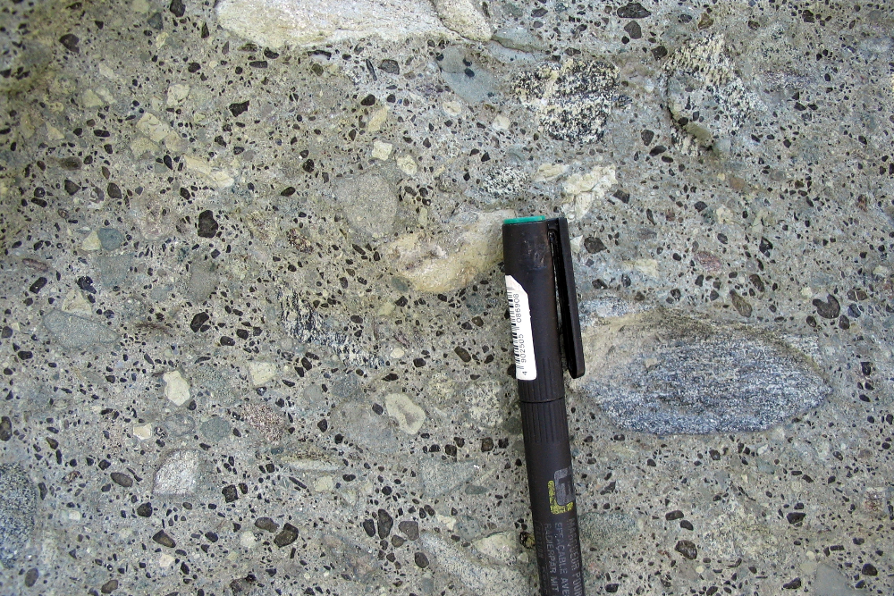 Diamond ore rock (kimberlite) showing dark crystals (olivine) and fragments of rock that were formed during explosive volcanic eruptions.