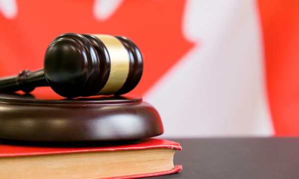 gavel and book in front of a Canadian flag