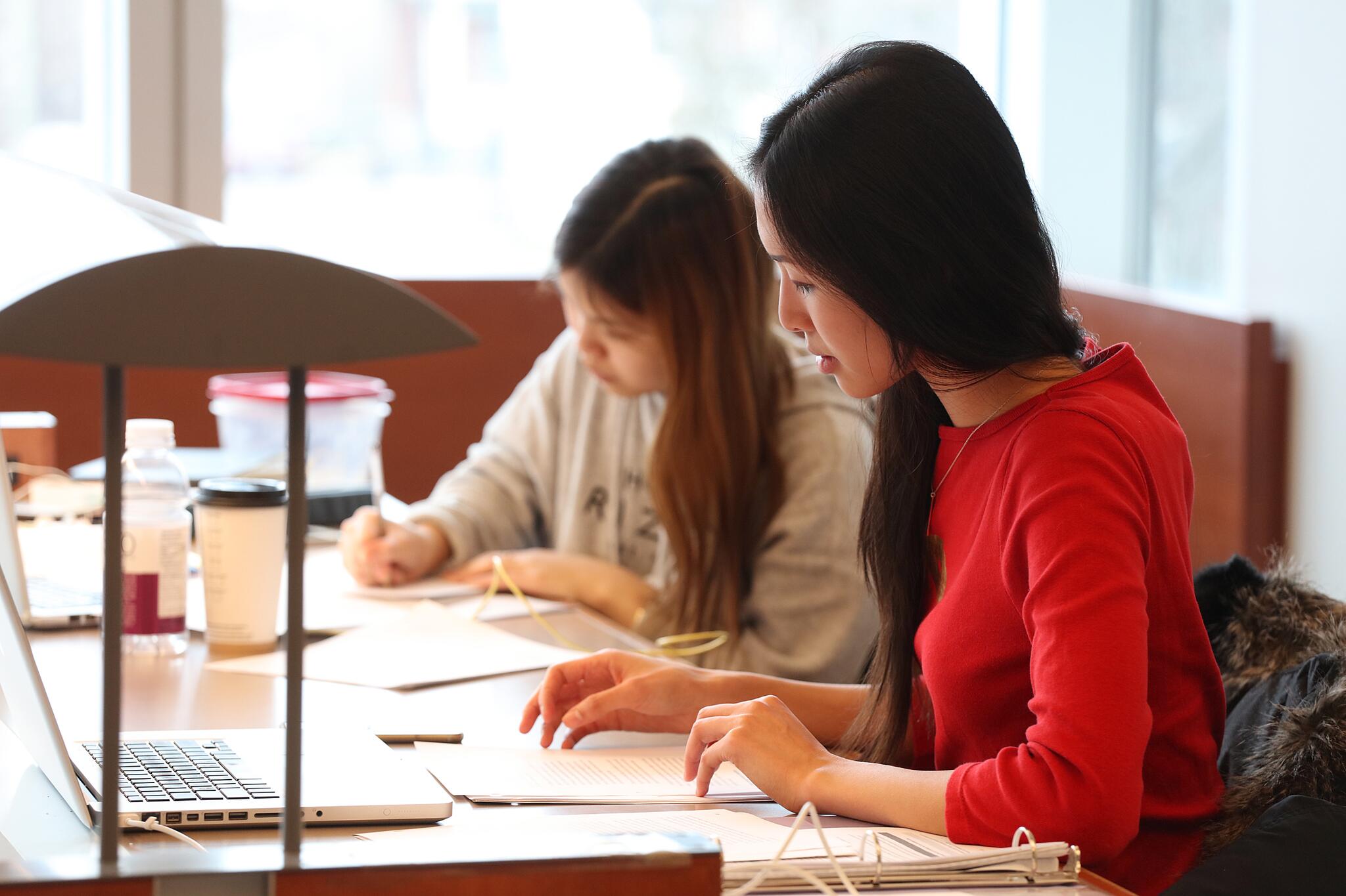 2 students working at a desk in Stauffer Library