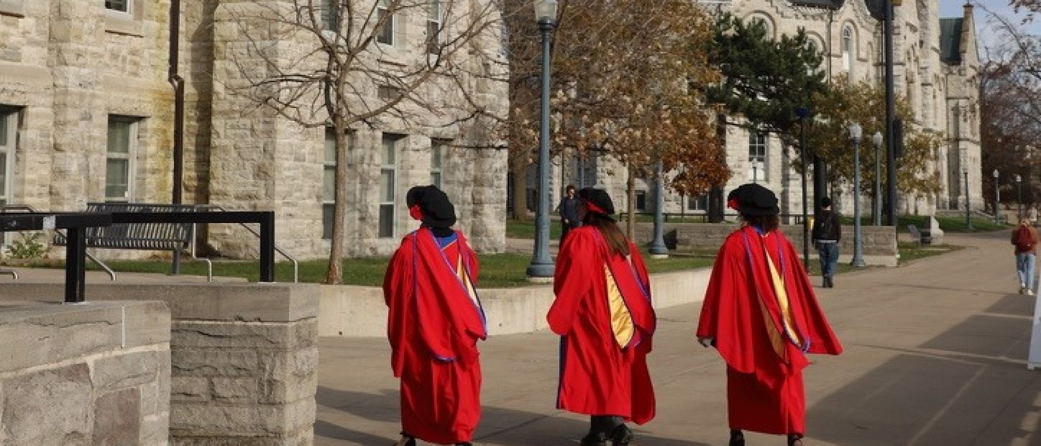 students walking in regalia 
