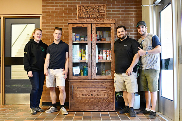 [A team of technological education students create a space at Duncan McArthur Hall to share and pick up non-perishable food items.]