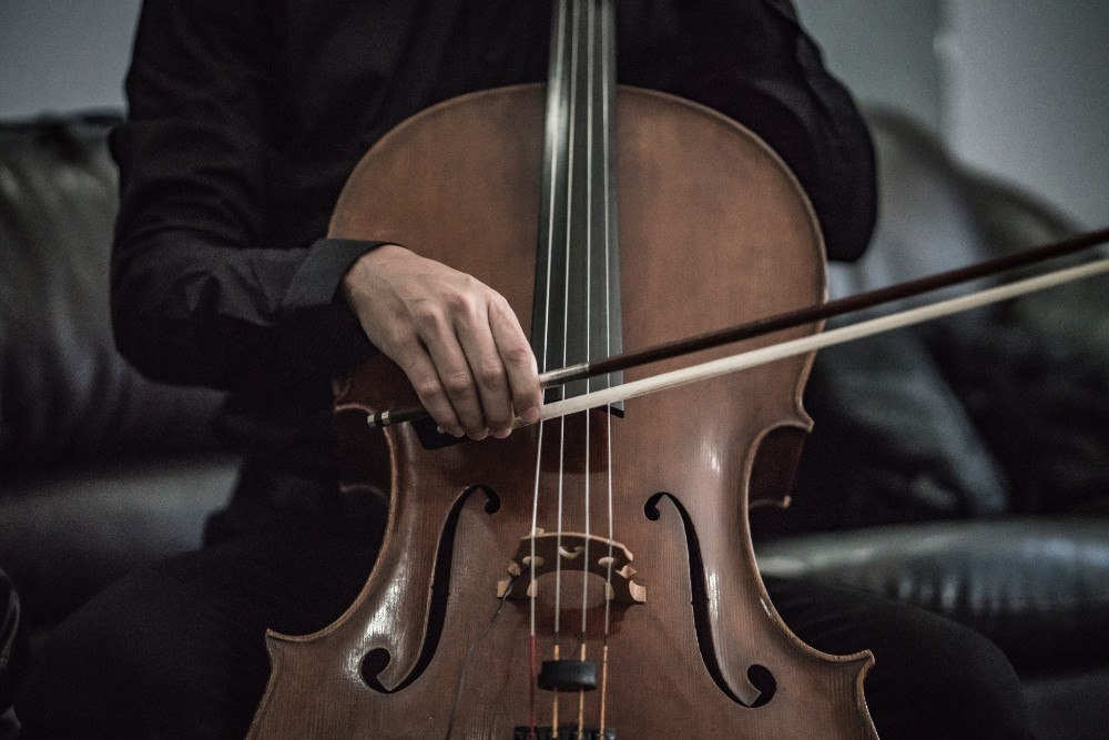 Photograph of a person playing the cello.
