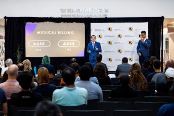 Two students make a pitch while on stage