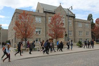 students walking along a campus street