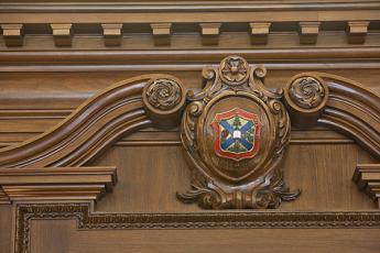 [Queen's University crest carved in wood]