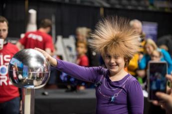 [Photo of a student learning about static electricity]