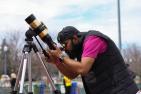 Nikhil Arora views the eclipse through a telescope
