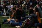 Students sit in darkness of totality