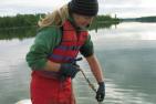 Queen's researcher Diane Orihel taking samples of lake water.