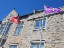The Anishnaabe and Haudenosaunee flags located in front of Richardson Hall.