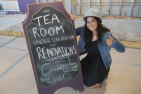 [Isabel Hazan (Sc'20), Head Manager of The Tea Room, updates the sign. (Photo: Queen's Alumni)]
