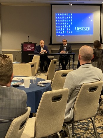 Upstate University Hospital CEO Dr. Robert Corona (left) and CEO of Kingston Health Sciences Centre Dr. David Pichora (right) discuss challenges and opportunities for hospital systems at the 2nd annual Kingston-Syracuse Pathway Cross Border Conference.
