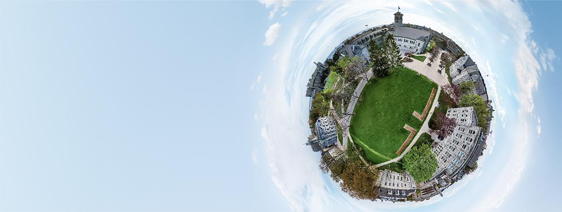 [Illustrative aerial drone shot of Queens University campus]