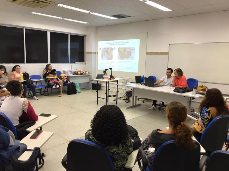 students and professors sitting in a circle