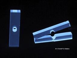 DCDC (double cleavage drilled compression) crystals fluorescing.
