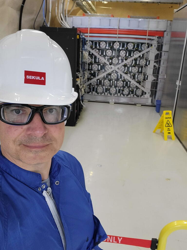 Dr. Sekula posing in front of the HALO detector