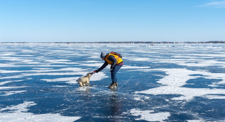 Larry Widrow on the lake with pet dog