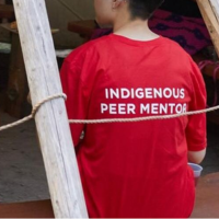 Indigenous Student wearing a peer mentor shirt
