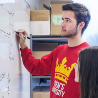 Students in the Stemina program solving an equation on a whiteboard