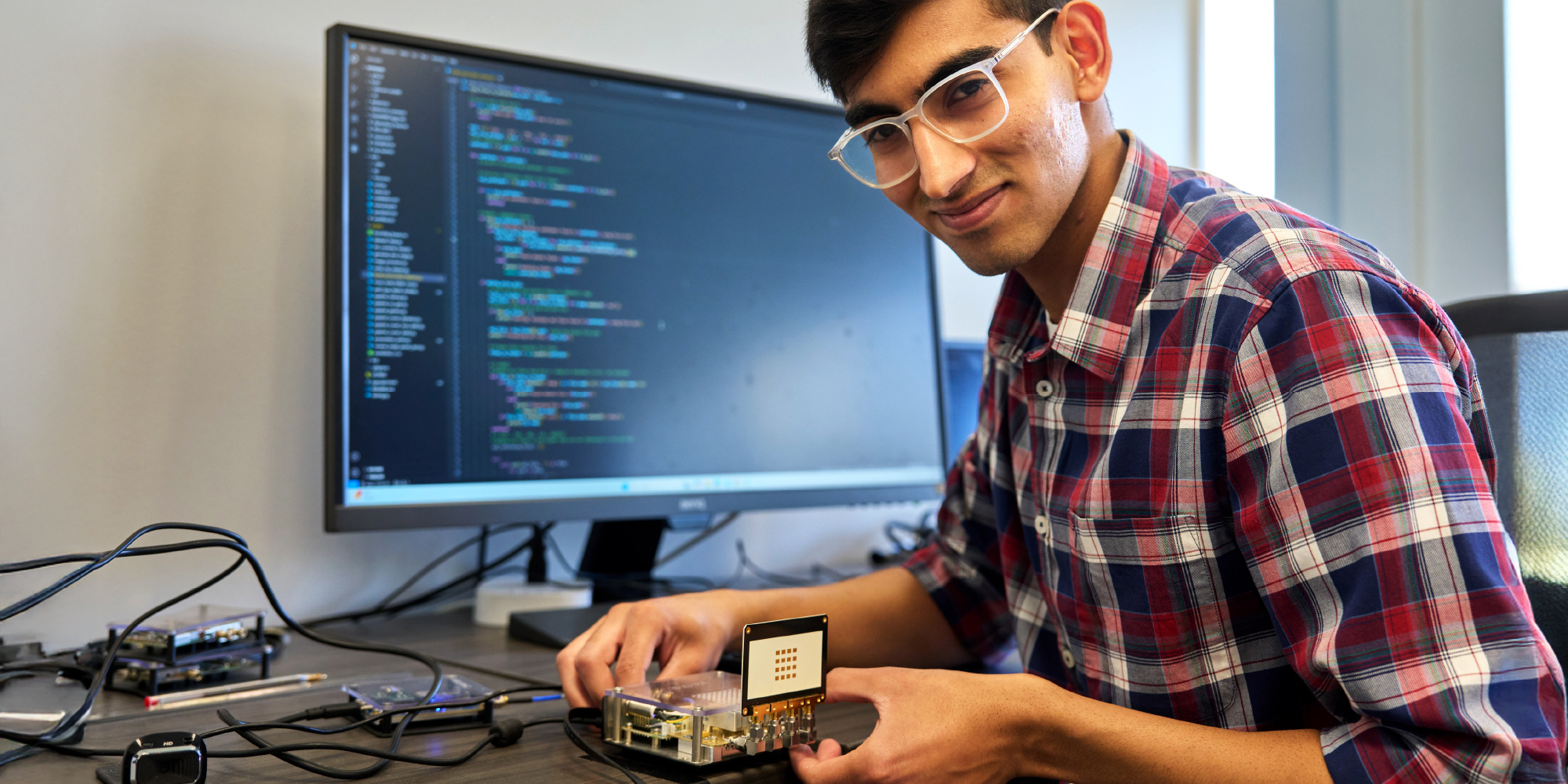 student holding computer parts