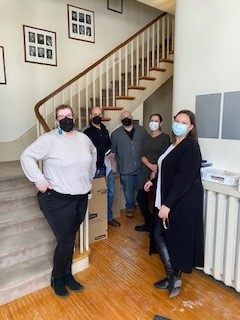 Members of Advancement stand in Summerhill wearing masks.