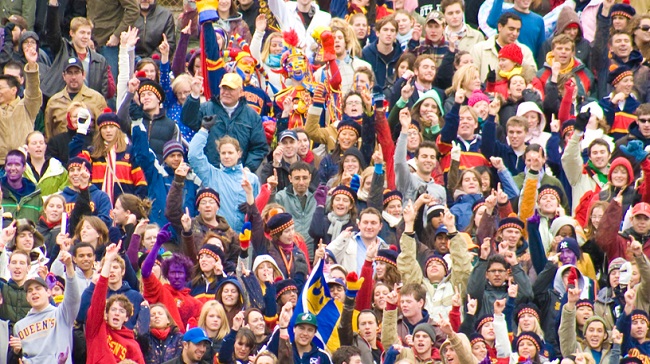 A crowd cheering at a Queen's sporting match