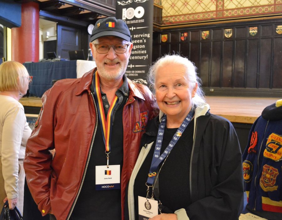 Robin Williams, Artsci'75, and John Reid, Artsci'75, smiling to the camera at Grant Hall.