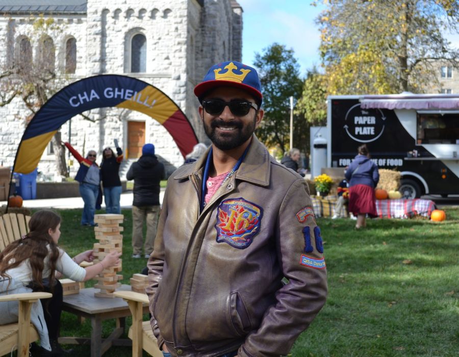Anish Muradia, Sc’16, wearing a Queen's jacket and enjoying Fall Harvest.