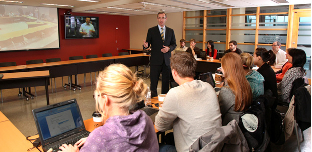Dean Flanagan teaching in new seminar room with videoconferencing technology