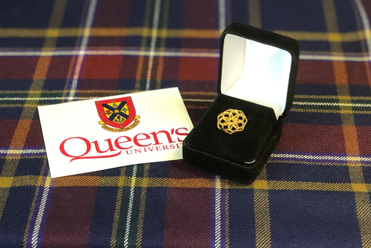 The Agnes Benidickson Award pin rests in a box on the Queen's tartan