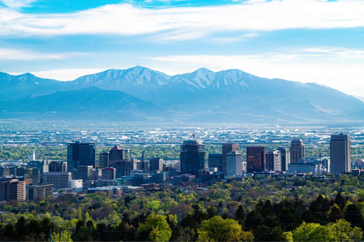 Salt Lake City, Utah skyline. Downtown buildings with mountains in the background.