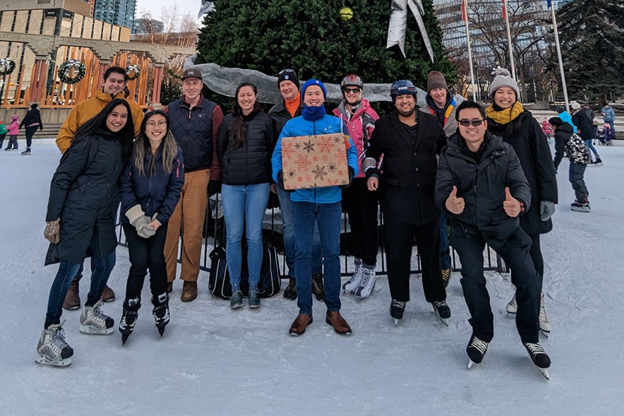 A group of alumni on skates at the Olympic Plaza rink