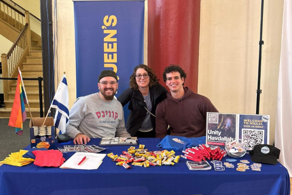 Members of the Jewish Alumni Chapter sit at an information booth inside Grant Hall.