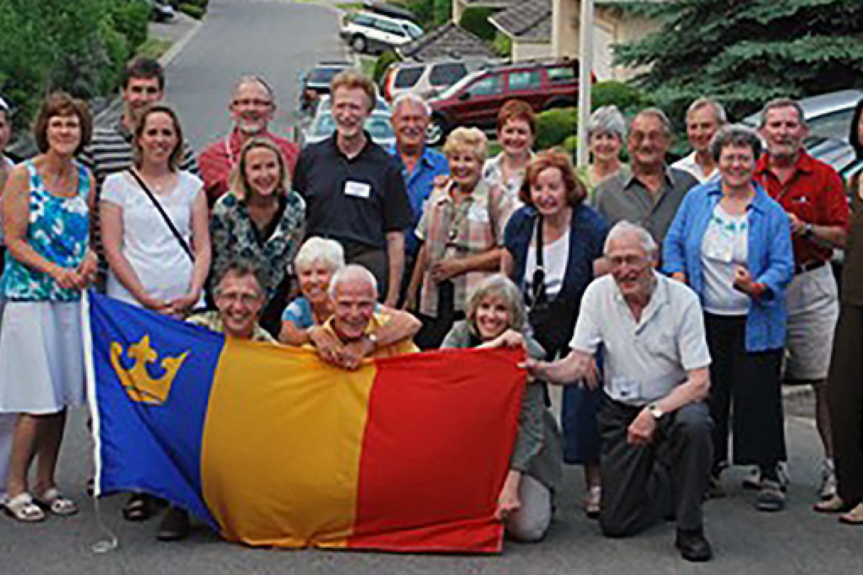 Okanagan alumni with flag