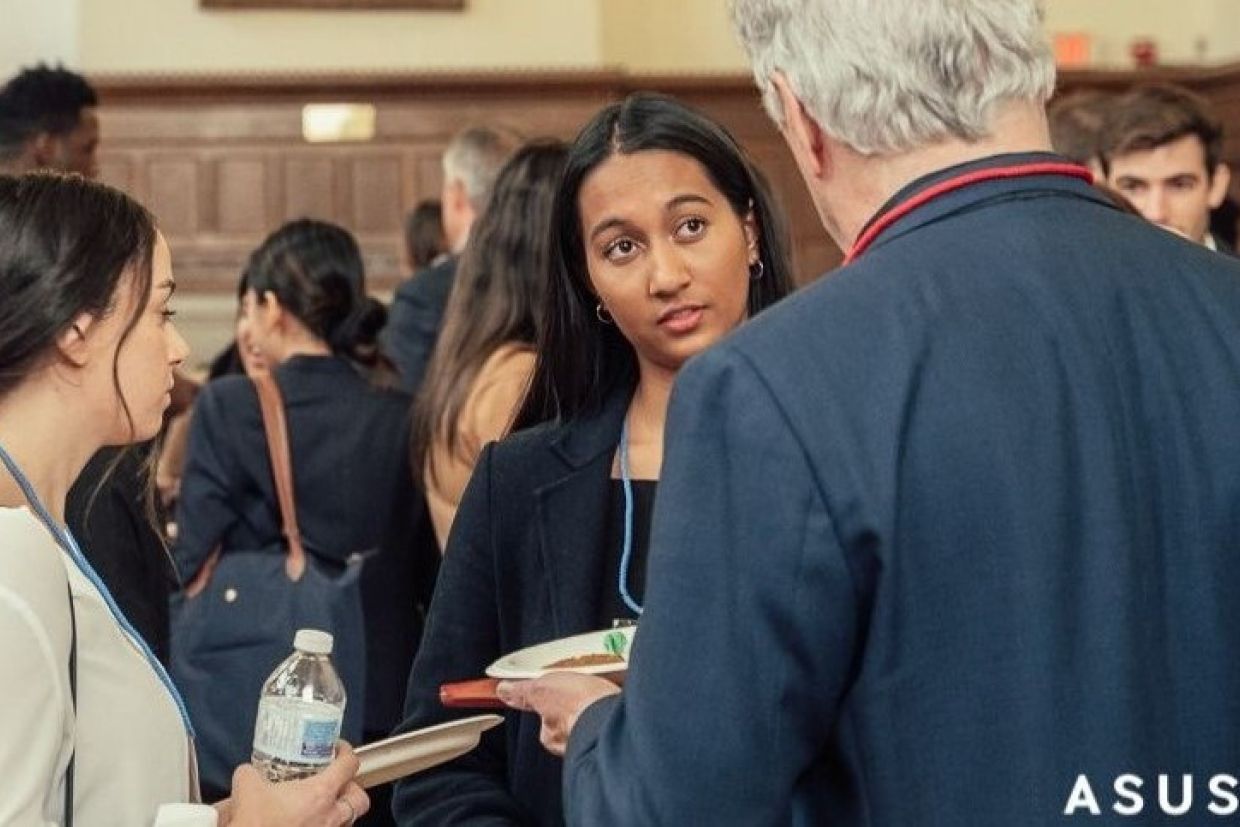 Two students in a networking discussion with an ArtSci Alumni at Life After ArtSci event