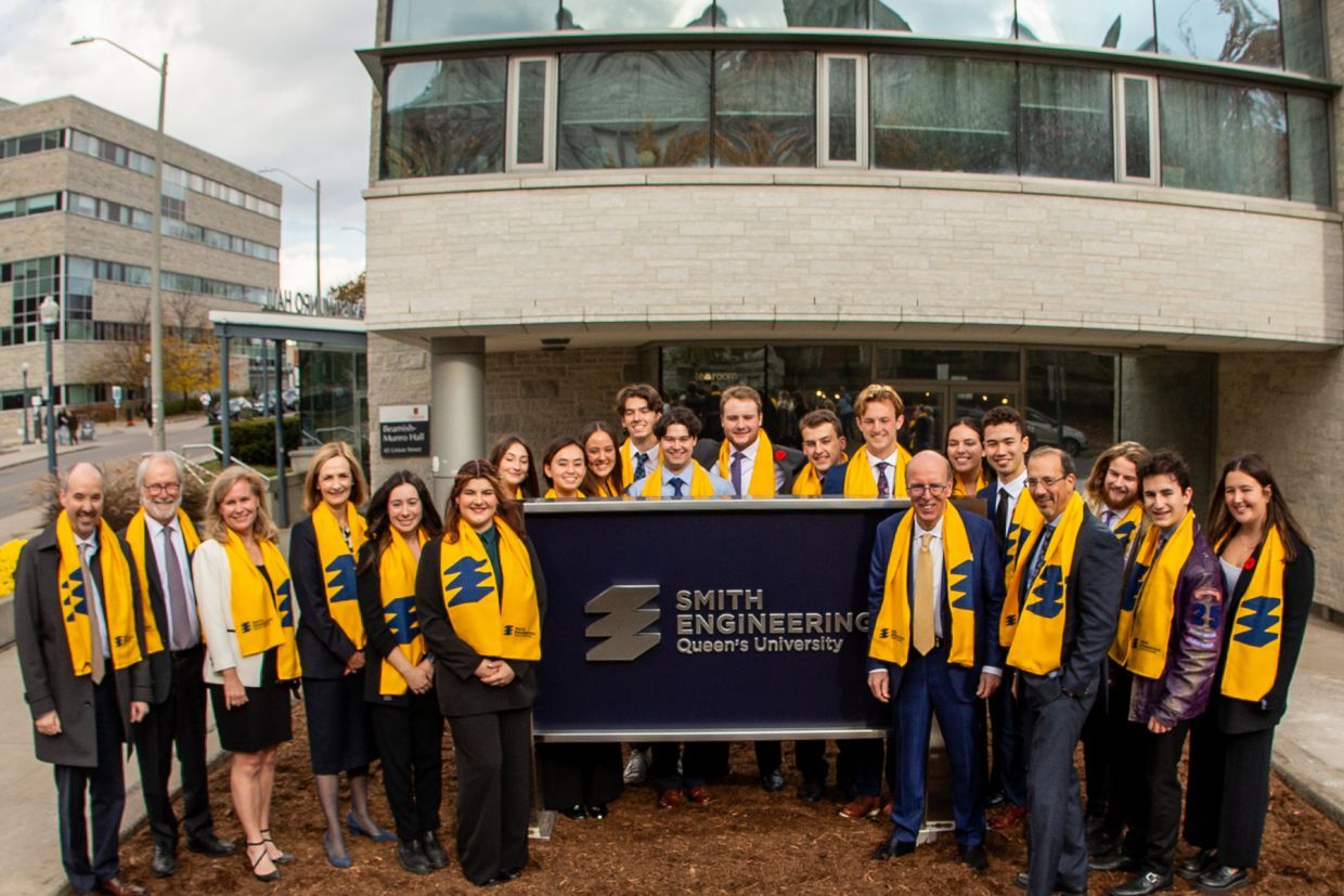 Students and faculty standing by the Smith Engineering sign outside of Beamish-Munro Hall