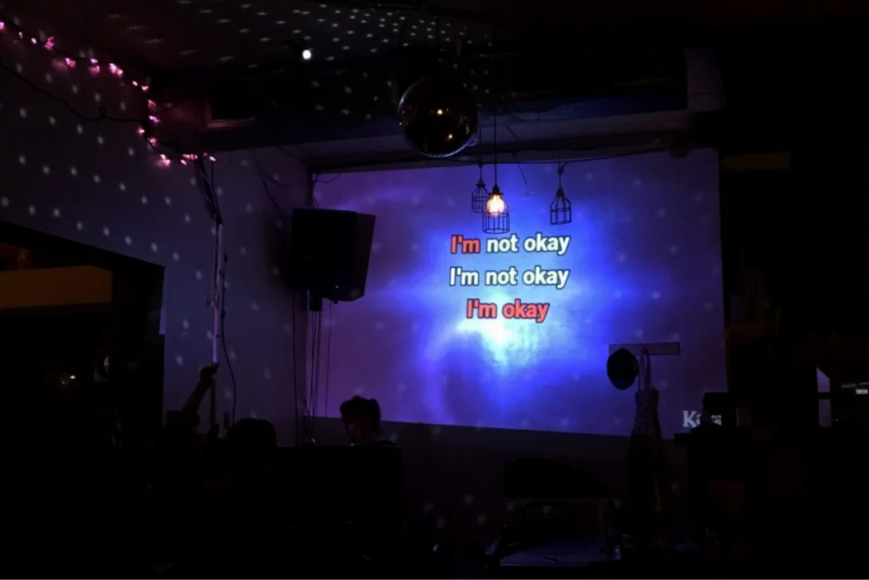 Karaoke screen showing the words "I'm not okay, I'm not okay, I'm okay"