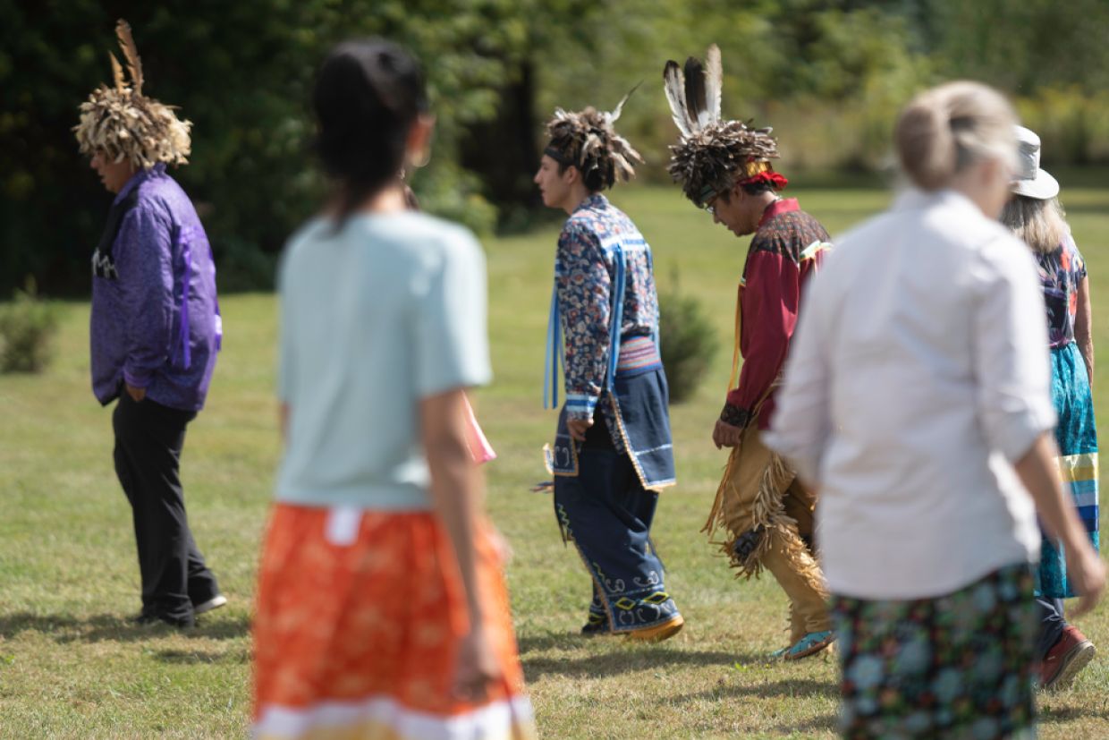 Indigenous dancers and Queen's alumni participating in the A Mile in Their Shoes program.