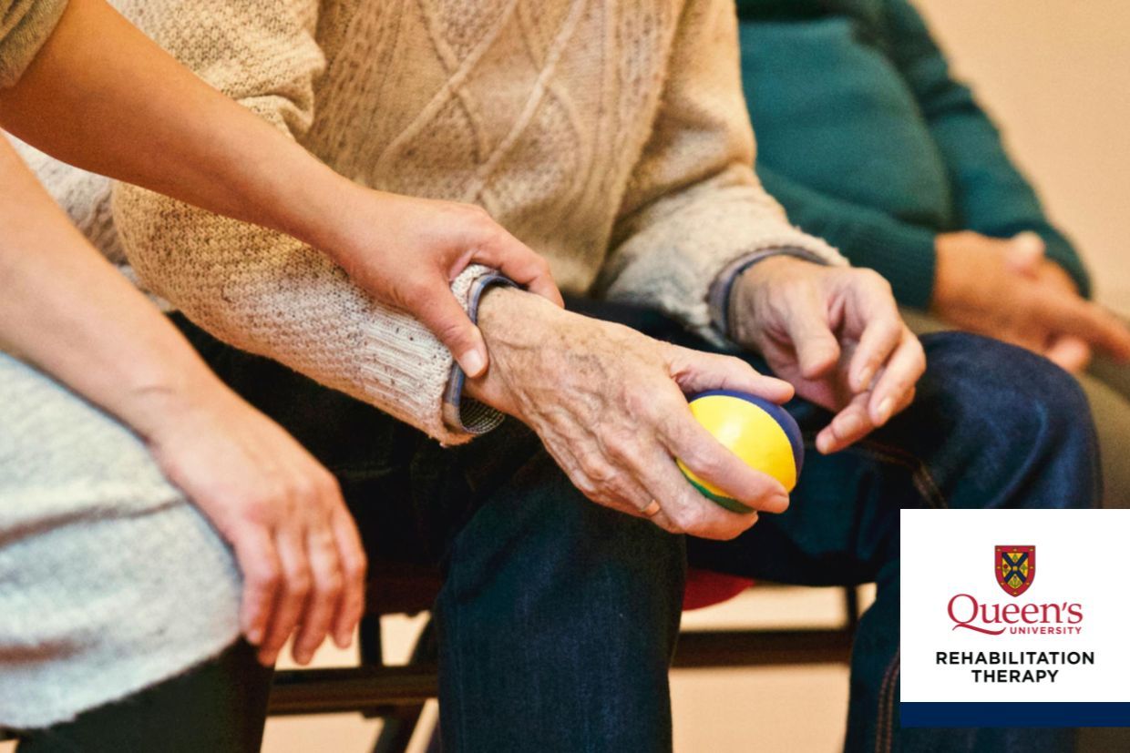 An individual presents a ball to an elderly person, representing interaction.
