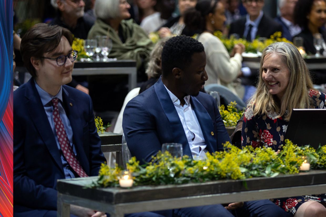 People sitting at a table smiling. 
