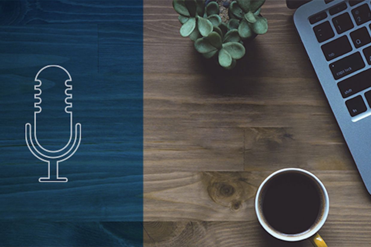 An aerial view of a laptop and coffee on a desk. On the left-hand side is an illustration of a radio microphone.