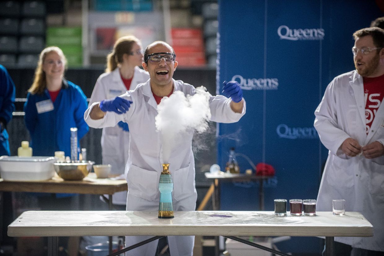Student in lab coat conducts an experiment