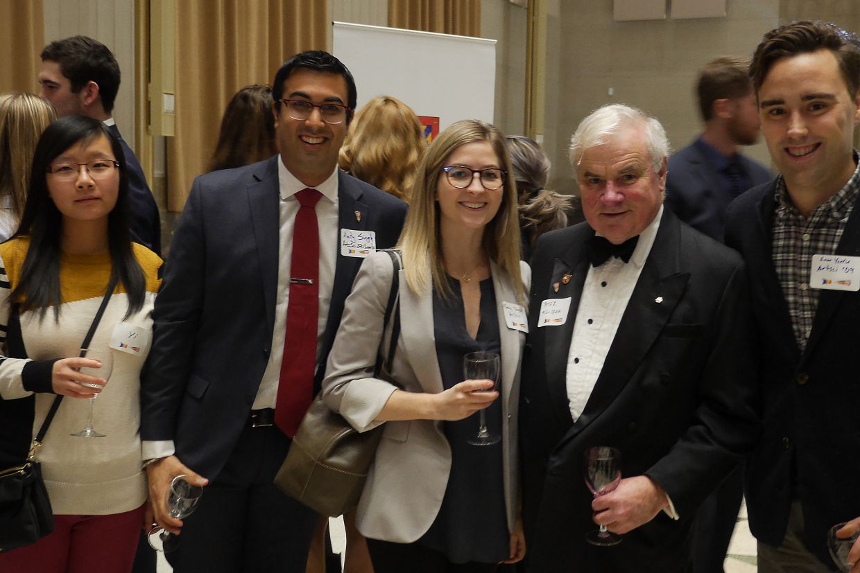 A group of alumni pose at a reception