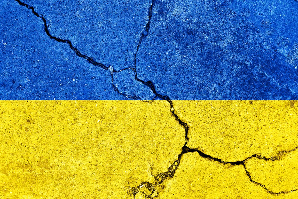 Ukraine flag on concrete with cracks